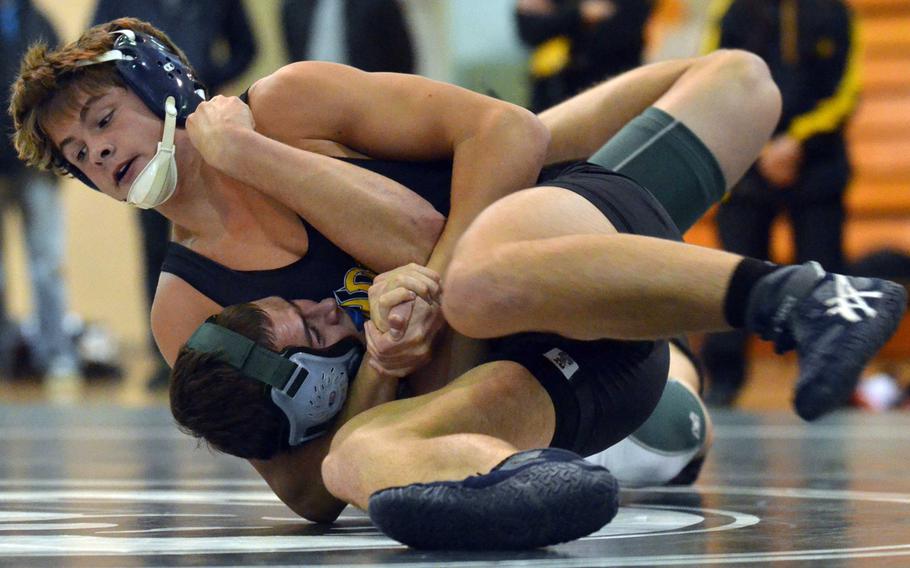 Kadena's Hunter Corwin locks in a head-and-arm hold on Kubasaki's Nick Pagel in the 158-pound bout during Wednesday's Okinawa high school wrestling meet. Corwin won by technical fall 10-0 in 1 minute, 47 seconds and the visiting Panthers won their second straight dual meet of the season 34-30.