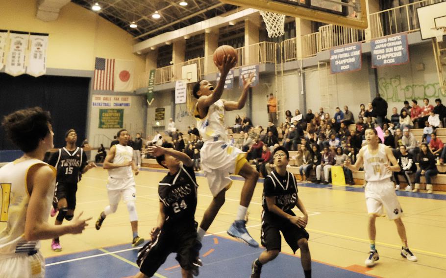 Yokota's Jaden Anderson drives the lane for a lay-up Dec. 18, 2014 at Yokota High School during the Panthers 106-44 victory over Zama. Anderson led all scorers with 26 points. 