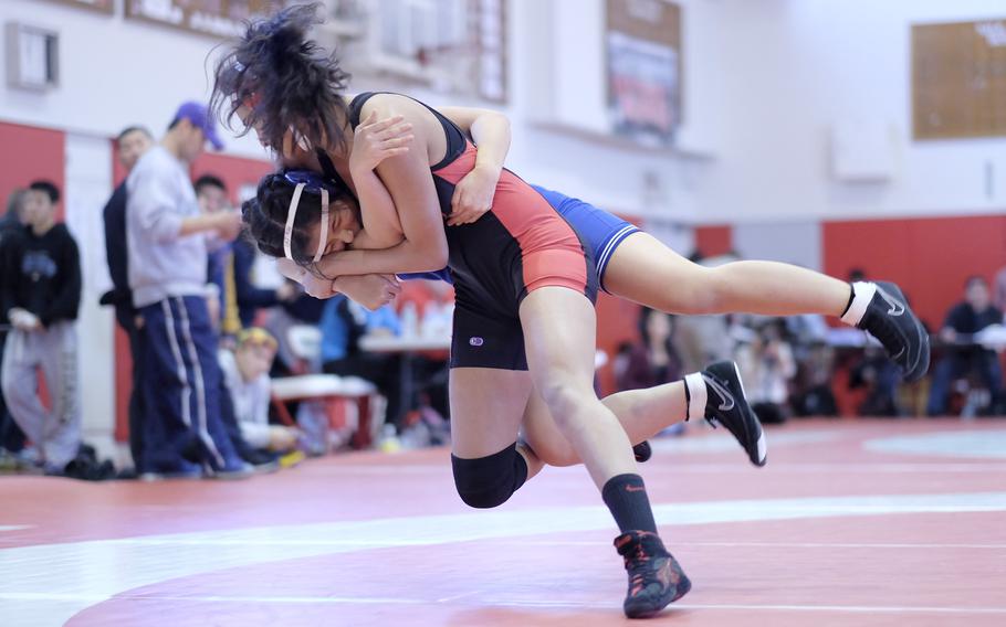 Nile C. Kinnick's Keisha Hadorn takes down Christian Academy of Japan's Yuri Ishihara in a 122-pound exhibition match at the Beast of the East.