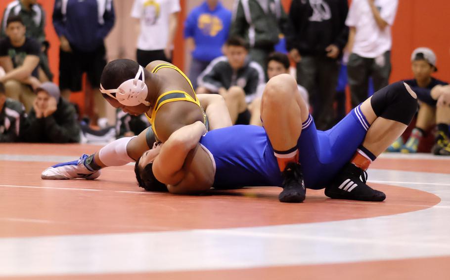Robert D. Edgren's Patrick Sledge pins Seoul American's Brendan Rothe in the 180-pound championship of the Beast of the East wrestling tournament.
