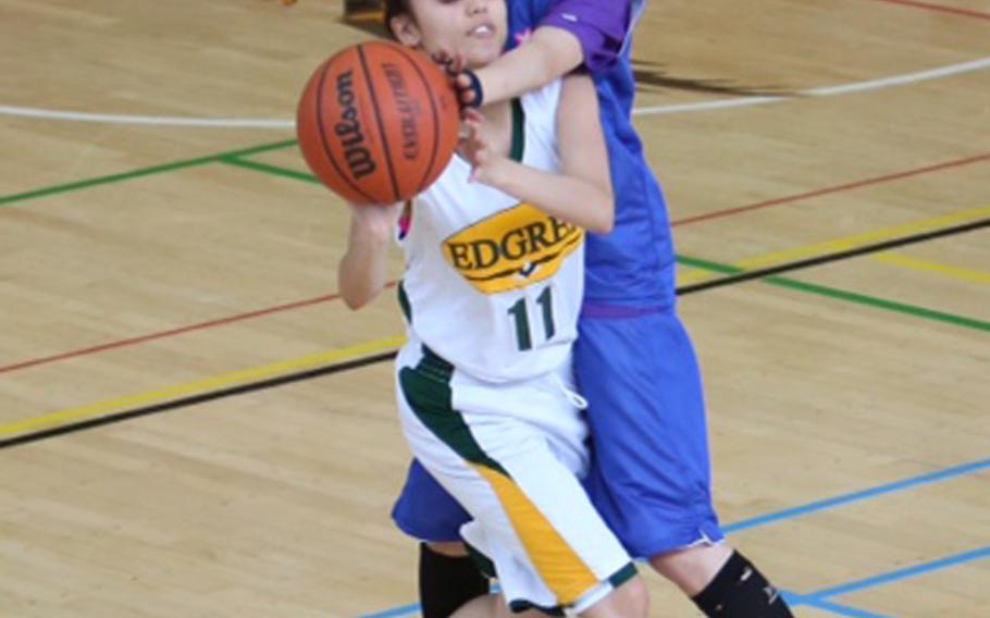 Robert D. Edgren's Courtney Ruble gets tangled up with Kosei's Kyoka Muroya during Saturday's game. Visiting Kosei edged the Eagles 65-60.