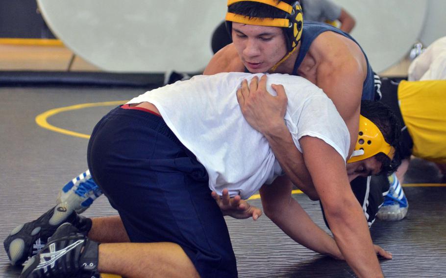 Kadena senior 168-pounder Ricky Salinas works a reverse gut wrench on practice partner Adrian Pinero on Tuesday. Salinas transferred from E.J. King in mid-December; he went 10-0 in two DODDS Japan tournaments before leaving Sasebo Naval Base.