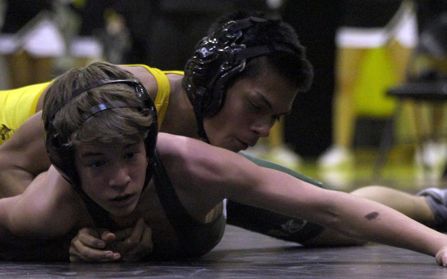 Kadena's Adam Trujillo assumes control of Kubasaki's Nick Jenkins at 115 pounds during Friday's dual meet at Kadena High School. Trujillo won by technical fall 11-0 in 5 minutes, 51 seconds, helping the Panthers cap a perfect 4-0 dual-meet season with a 38-25 win over the Dragons.