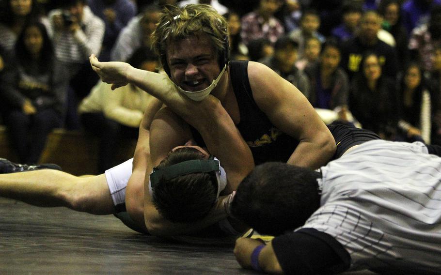 Kadena's Hunter Corwin gains the edge on Kubasaki's Nick Pagel at 158 pounds during Friday's dual meet at Kadena High School. Corwin pinned Pagel in 23 seconds, helping the Panthers cap a perfect 4-0 dual-meet season with a 38-25 win over the Dragons.