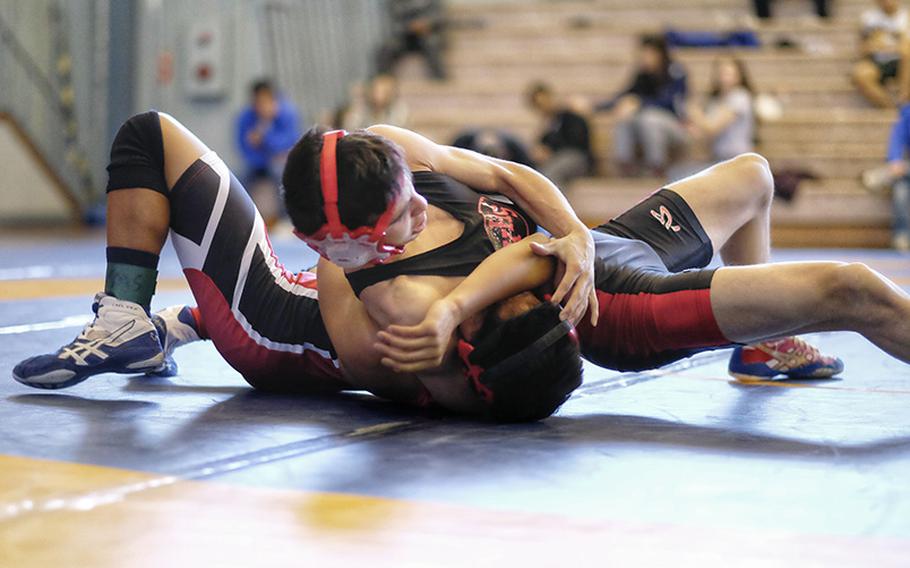 Nile C. Kinnick Vincent Soiles pins E.J. King Kaivan Taylor during the 115-pound championship match at the DODDS Japan Wrestling Tournament Jan. 24 at Yokota High School in Fussa, Japan.