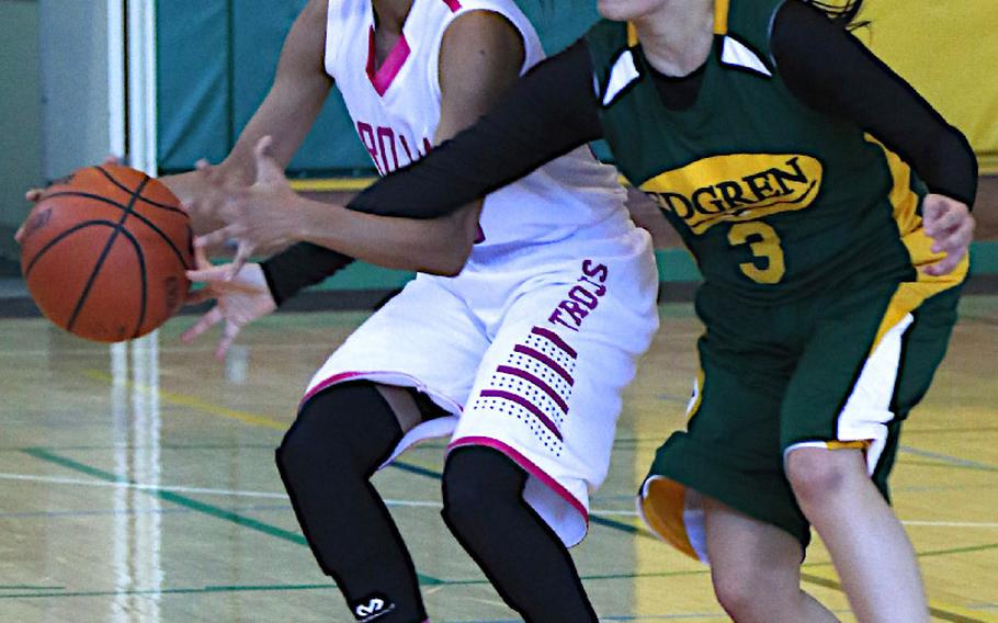 Zama American's Tiarra Carroll and Robert D. Edgren's Vanessa Black fight for the ball during the Japan girls basketball game, Jan. 24, 2015. The Eagles won 59-26.