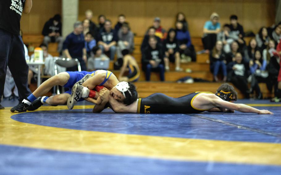 Saint Mary's Chang Young Lee leg laces American School in Japan's Lochlan Fahy in the 108-pound championship match of the Kanto Wrestling Invitational at Christian Academy in Japan in Higashikurume, Japan.