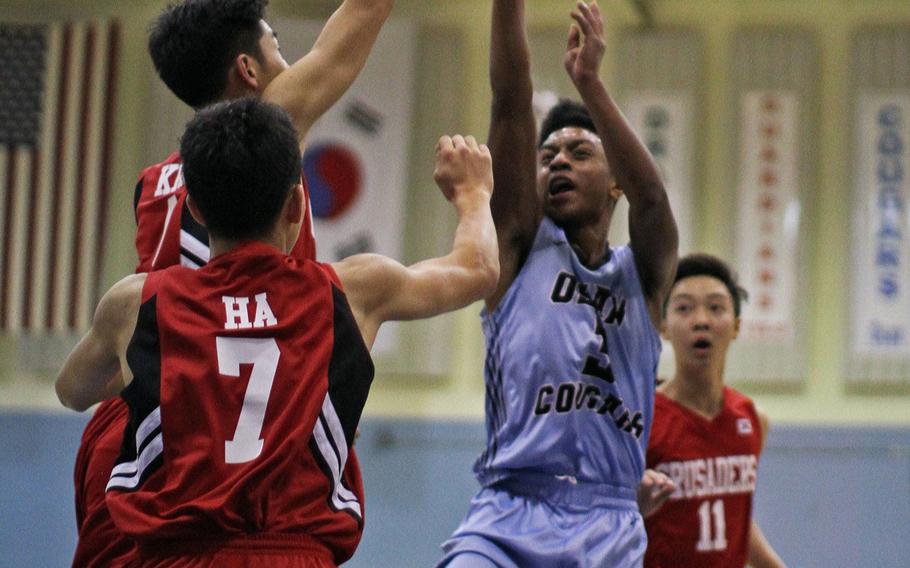 
Yongsan's Joshua T. Kim goes for the layup out of the reach of Humphreys defender Daiquon Wilson. The Guardians beat the Blackhawks 64-62 in the Korean American Interscholastic Activities Conference Blue Division tournament on Friday, Feb. 6, 2015.

