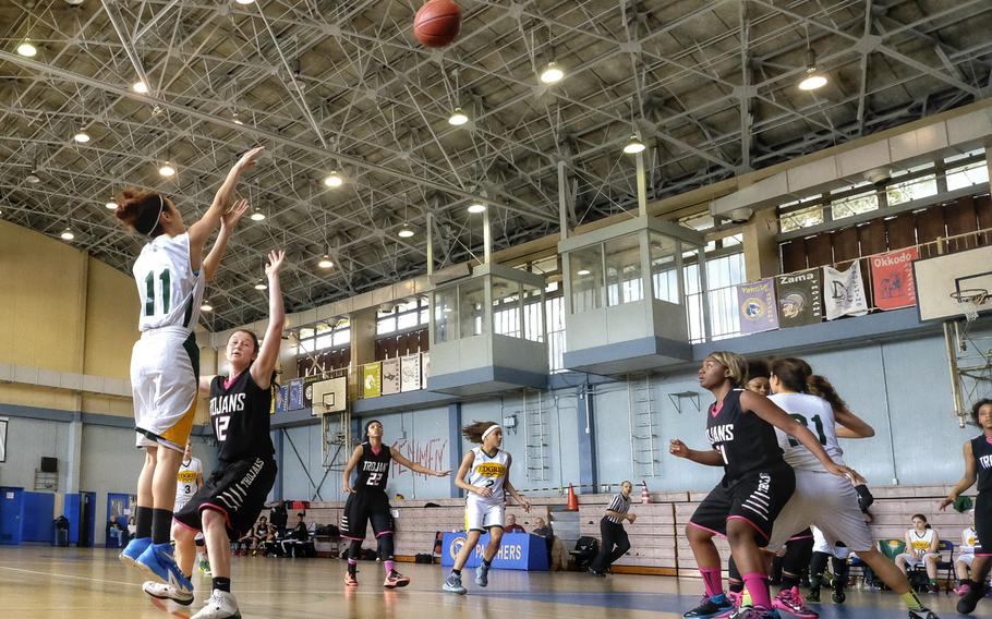 Robert D. Edgren's Courtney Ruble launches a three-point shot attempt over Zama's Malina Camacho during the third-place game of the DODDS Japan Basketball Tournament on Saturday at Yokota Air Base, Japan. Edgren would win 35-29.