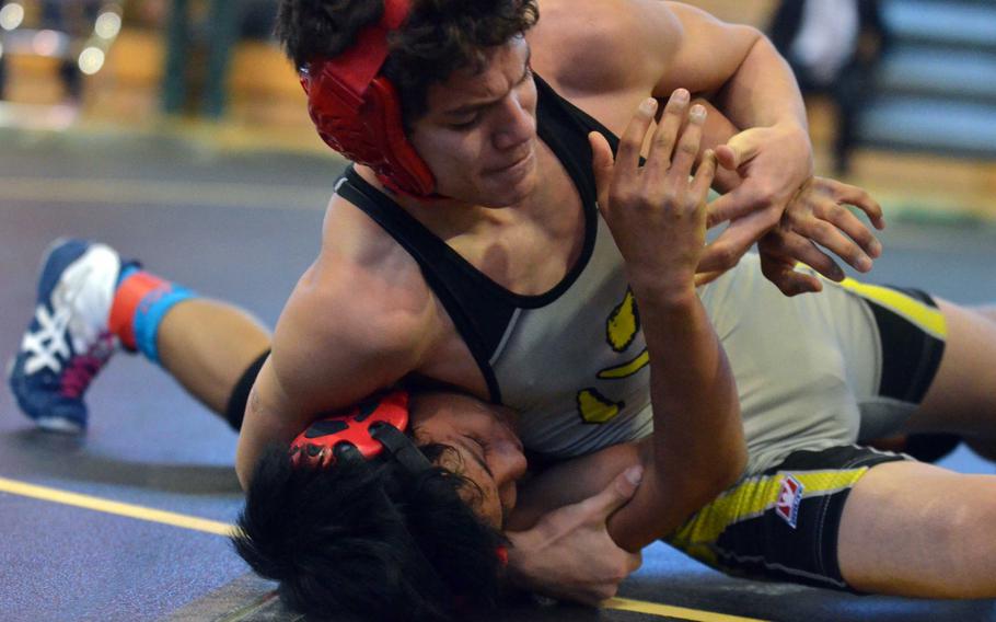 Nile C. Kinnick's Chon Dareing tries to lock in a head-and-arm hold on E.J. King's Kaivan Taylor during an early-round 115-pound Far East Wrestling Tournament bout. Dareing won a 10-9 decision.