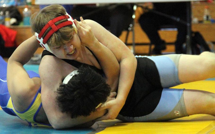 Christian Schmitz of Osan locks in a head-and-arm hold on St. Mary's Joon Seo Bae during a knockout-round 180-pound Far East Wrestling Tournament bout. Schmitz pinned Bae.