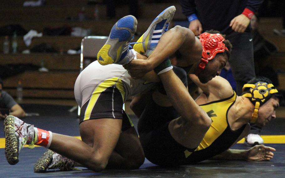 Nile C. Kinnick's Dre Paylor gets the edge on Kadena's Ricky Salinas during Friday's 168-pound Far East tournament title bout. Paylor won by technical fall 15-4.