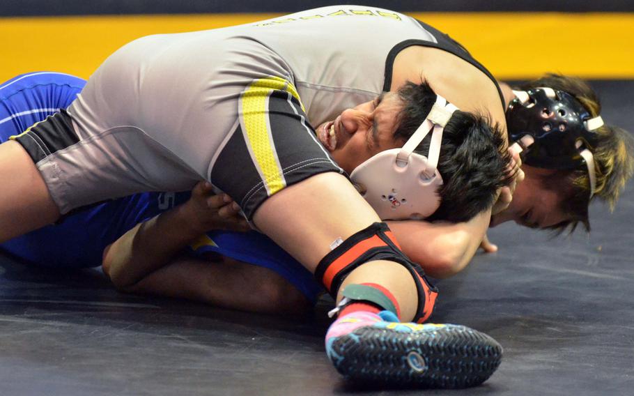 Lucas Wirth of Nile C. Kinnick takes control as St. Mary's Eshan Singhi grimaces in the 101-pound bout during Saturday's Far East tournament Division I dual-meet final. Wirth pinned Singhi in 35 seconds and Kinnick rallied from a 19-7 deficit to win the meet 29-26.