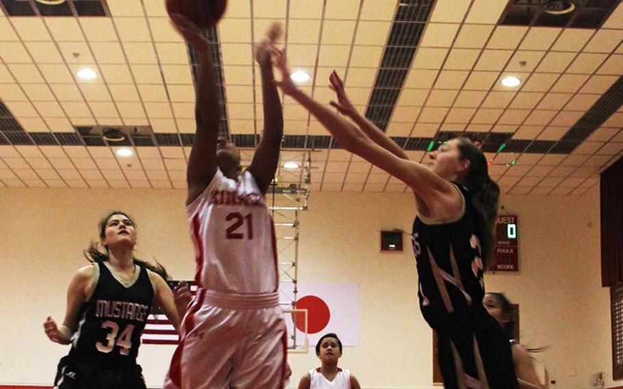 Nile C. Kinnick's Lexia Hall goes up for a shot between two ASIJ defenders Wednesday during the 2015 Far East Division I girls championship game. ASIJ won 46-38. 