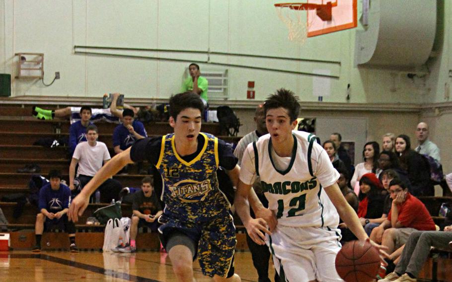 Kubasaki's Skylor Stevens maneuvers around St. Mary's defender Eamon Collins on Wednesday during a Day 3 semifinals game at the Far East boys Division I tournament. Kubasaki won 56-34.