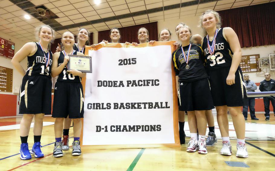 American School In Japan poses with its championship banner following a 46-38 win in the girls' Division I Far East Tournament championship game on Wednesday, Feb. 18, 2015, at Naval Base Yokosuka, Japan. ASIJ repeated as champion and collected its third overall title. 