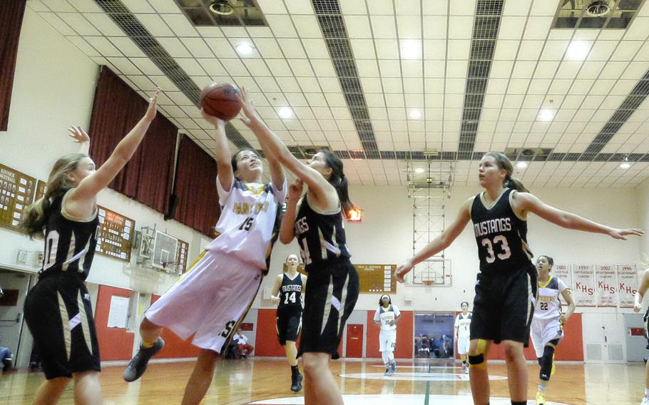 Kadena's Linda Vaughan looks for a shooting lane as American School In Japan's Kate Latimore and Allie Rogers defend during the girls' Division I Far East Tournament championship game on Wednesday, Feb. 18, 2015, at Naval Base Yokosuka, Japan. ASIJ's triangle and two defense slowed a Kadena offense that had averaged 28-point victories in their previous five tournament games en route to a 46-38 win.
