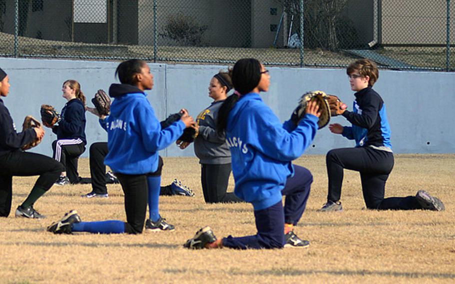 Seoul American softball players go through their warmup paces at Wednesday's practice at Lombardo Field on Yongsan Garrison.