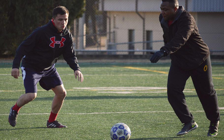 Seoul American senior defender Max Weekley works out with assistant coach Frantcy Diego. The Falcons are in a rebuilding year after having lost seven starters from last year's team.