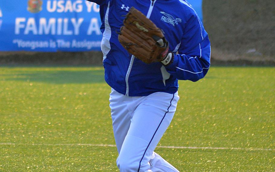 Seoul American outfielder JoJon Cabrera tosses from the outfield during Falcons' Wednesday practice.