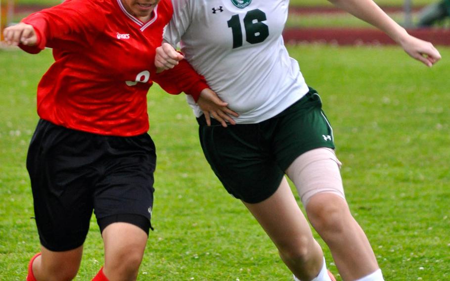 Kubasaki sweeper Peyton Lewis battles a Naha Nishi player for the ball during Saturday's season-opening match for the reigning Far East Division I Tournament champion Dragons; they won 2-0.