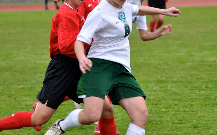 Kubasaki midfielder Reiko Lemasters sets to boot the ball away from Naha Nishi opponents during Saturday's season-opening match for the reigning Far East Division I Tournament champion Dragons; they won 2-0. 