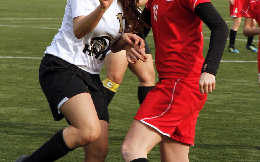 Humphreys' Kaylee Spielman and Seoul Foreign's Nina Bernhardt scrum for the ball during Saturday's Korea girls soccer match. The Crusaders downed the Blackhawks 10-1.
