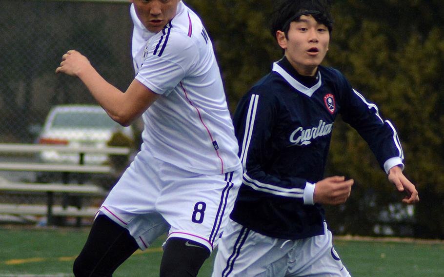 Seoul American's Max Weekley and Yongsan's Hannes Schwedhelm battle for the ball during Wednesday's Korea boys soccer match, won by the host Falcons 1-0.
