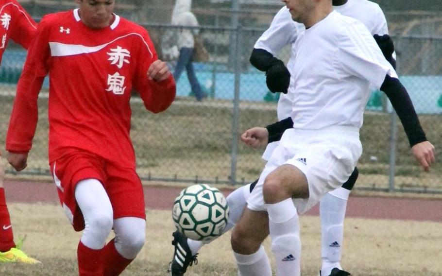Nile C. Kinnick's Chon Dareing and Robert D. Edgren's Gabriel Schultz battle for the ball during Friday's DODDS Japan boys soccer match. The Red Devils won 3-2.