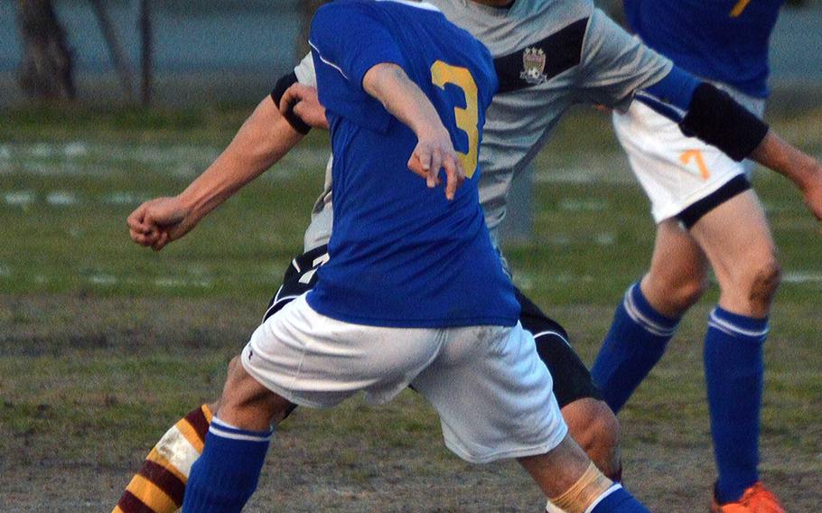 Matthew C. Perry's Dylan Ernst and Yokota's Ray Hernandez battle for the ball during Friday's DODDS Japan boys soccer match. The teams played to a 3-3 draw.