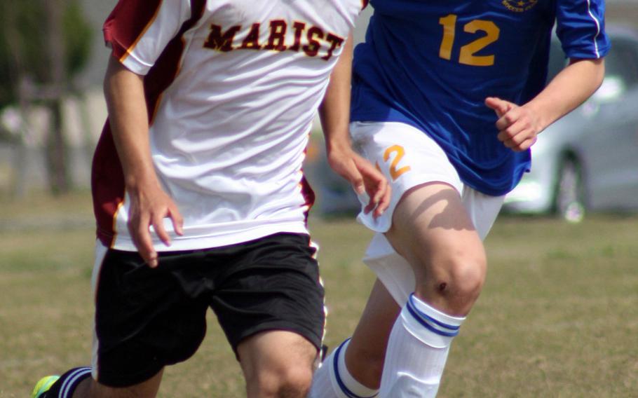 Marist Brothers' Lucas Sant'Anna gets chased by Yokota's Keanu McElroy during Saturday's Perry Cup tournament match. The Bulldogs blanked the Panthers 1-0.