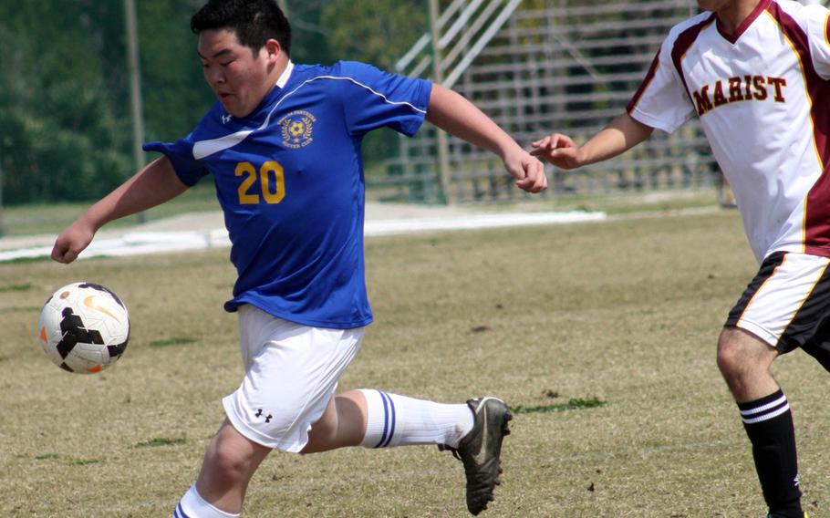 Yokota's Justin Pho boots the ball in front of Marist Brothers' Lucas Sant'Anna during Saturday's Perry Cup tournament match. The Bulldogs blanked the Panthers 1-0.