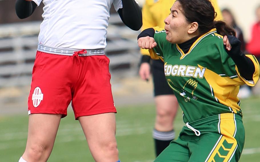 Nile C. Kinnick's Raena Schoeff heads the ball next to Robert D. Edgren's Gabriela Gonzalez during Saturday's DODDS Japan girls soccer match. The Red Devils won 5-0 to sweep the weekend series.