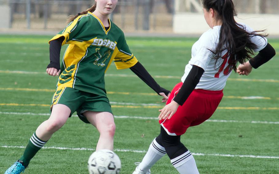 Robert D. Edgren's Elizabeth Long and Nile C. Kinnick's Kiralyn Kawachi scrum for the ball during Saturday's DODDS Japan girls soccer match. The Red Devils won 5-0 to sweep the weekend series.