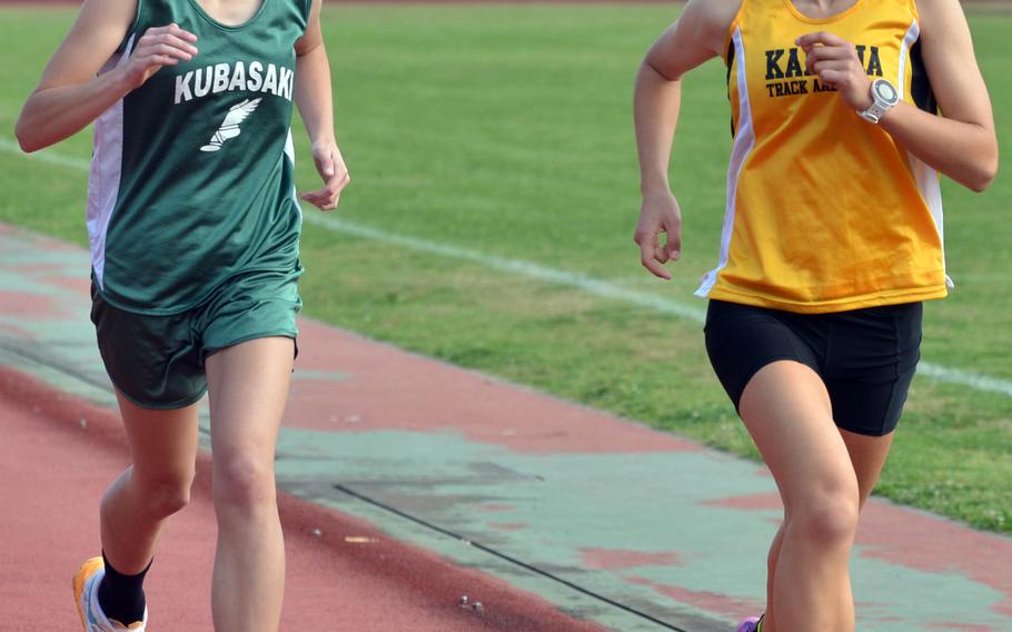 Kubasaki's Zoe Jarvis and Kadena's Wren Renquist lead the pack during the 3,200-meter run in Saturday's Okinawa season-opening track and field meet. Renquist swept the 3,200, 1,600 and 800 races.
