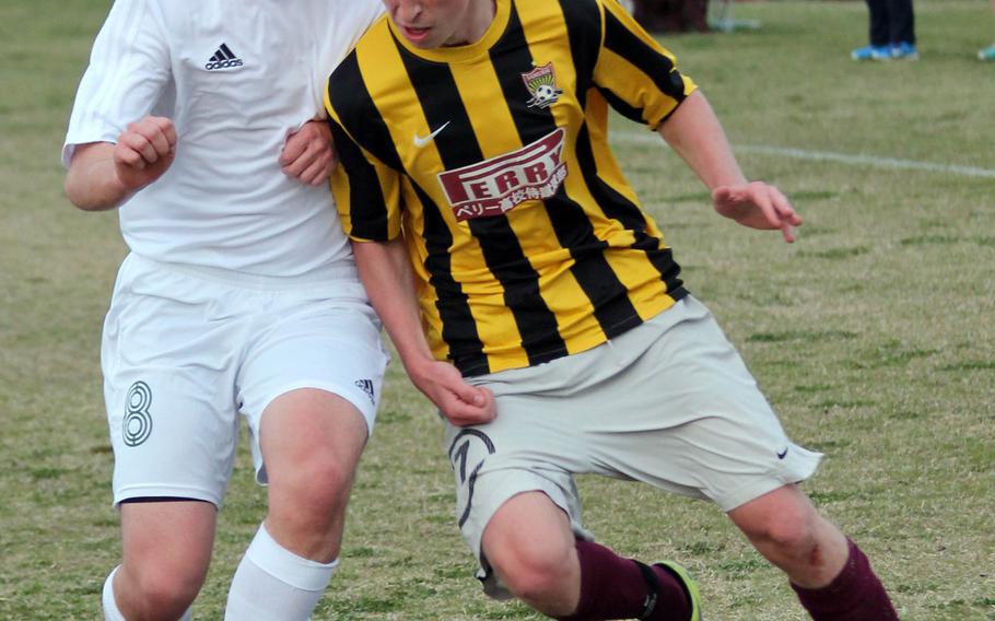 Robert D. Edgren's Nick Cunniff and Matthew C. Perry's Aidan Lewis battle for control of the ball during Friday's DODDS Japan boys soccer match. The Samurai beat the Eagles 6-1.