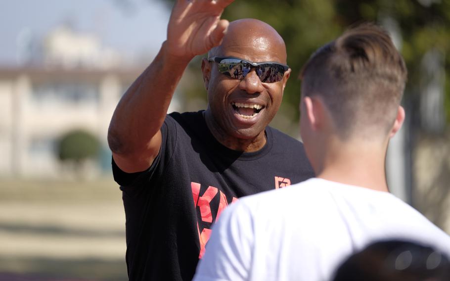 Mike Powell, a two-time world champion and the world record holder in long jump, coaches high school and middle school athletes at Yokota Air Base, Japan on Sunday, March 29, 2015. Powell was among four former Olympians to visit Yokota.