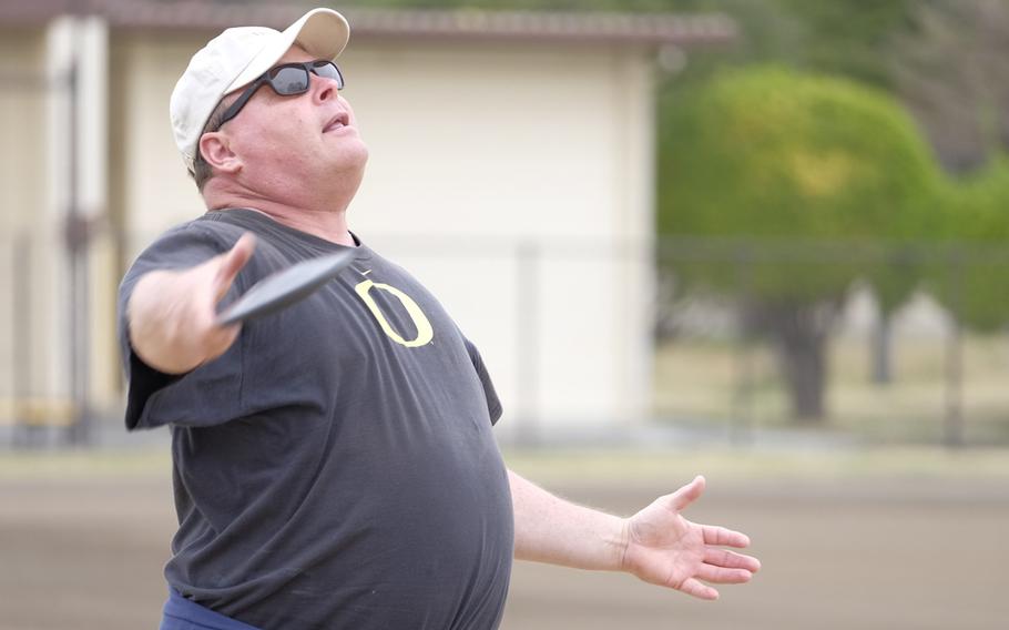 Ken Flax, a two-time Olympian in the hammer throw, coaches discus fundamentals to high school and middle school athletes at Yokota Air Base, Japan on Sunday, March 29, 2015. Flax was among four former Olympians to visit Yokota as part of the World Records Camp.