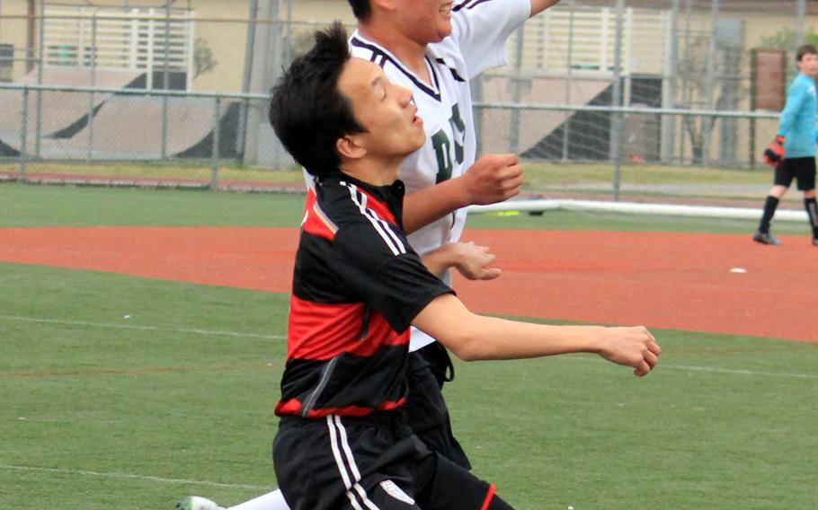Daegu's Myong Yi and Seoul Foreign's Tyler Ryoo go up to head the ball during Thursday's Korea boys soccer match. The visiting Crusaders routed the Warriors 10-0.