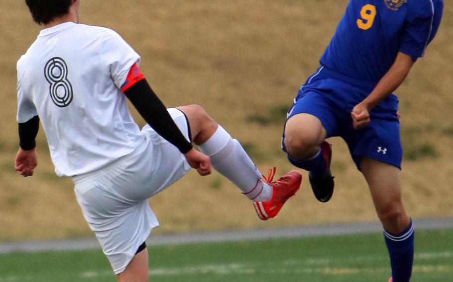 Robert D. Edgren's Nick Cunniff and Yokota's Connor Standbridge try to play the ball during Friday's DODDS Japan boys soccer match. The visiting Panthers blanked the Eagles 4-0.
