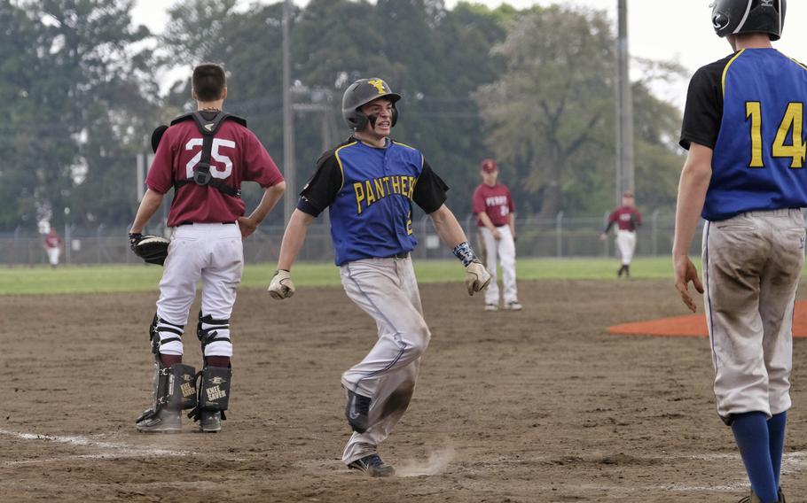Yokota's Easton Gladue struts across the plate following a three-run inside the ballpark home run that ended a 12-2 victory over M.C. Perry during the DODDS Japan Tournament at Camp Zama, Japan on Friday, April 17, 2015. The homer forced the mercy rule to come into effect at the end of the fourth inning.