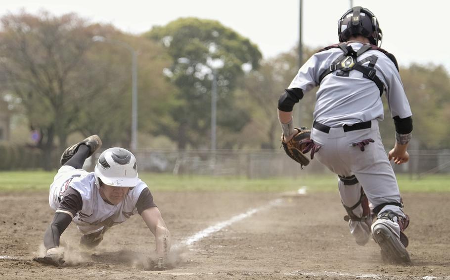 Zama's Jake Bayardo slides into home off a sacrifice bunt to score the tying run against Matthew C. Perry during the DODDS Japan Tournament at Camp Zama, Japan on April 18, 2015. Zama and Perry tied 5-5 due to time constraints.