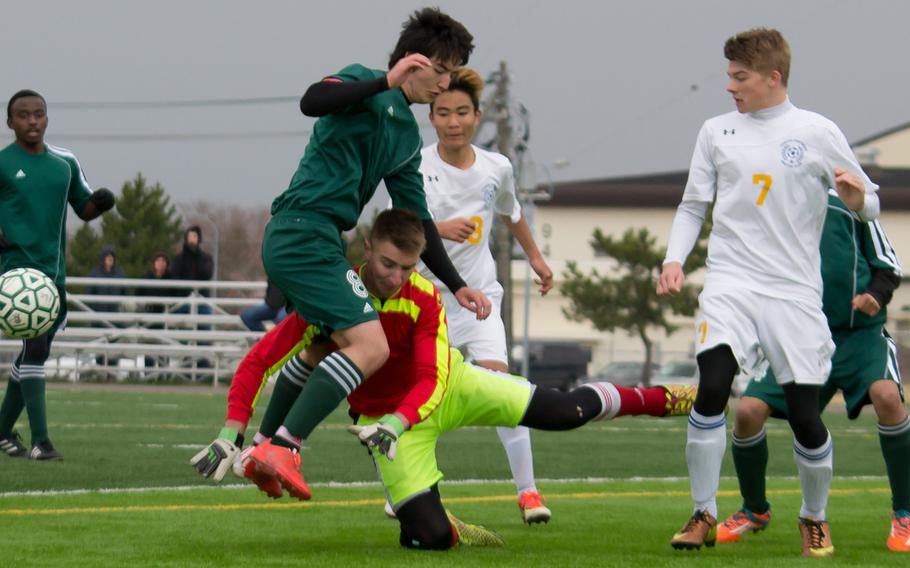Robert D. Edgren's Nick Cunniff has the ball batted away by Yokota goalkeeper Chris Rickenbach as Panthers teammate Jack Liddle watches during Saturday's DODDS Japan boys soccer match. The visiting Panthers downed the Eagles 5-2.
