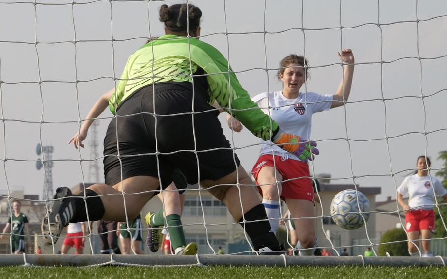 Nile C. Kinnick's Alexia Storey takes a shot on goal April 23, 2015 during the DODDS Japan District girls soccer tournament at Yokota Air Base, Japan. The Red Devils won 8-1.