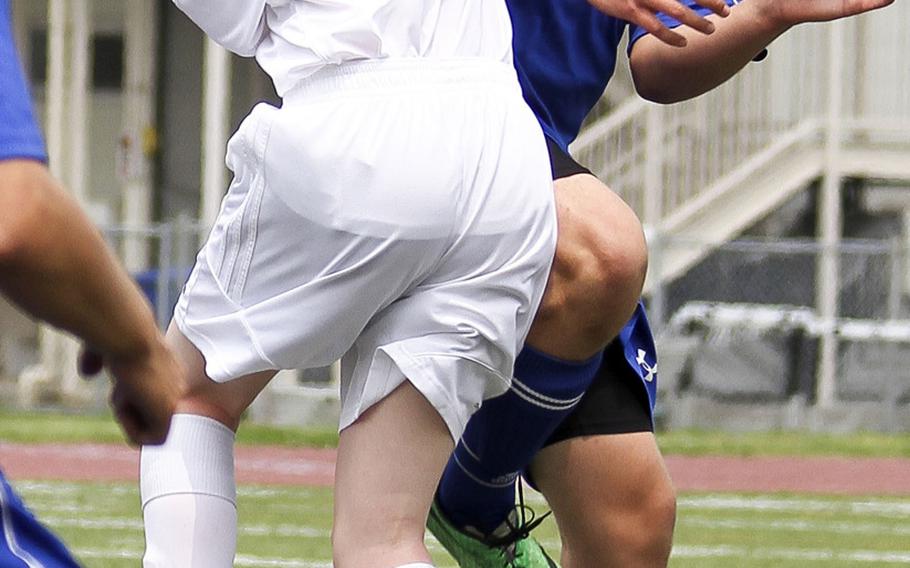 Robert D. Edgren's Michael Winters and Yokota's Mark Crate make a play for the ball during Saturday's third-place match in the DODDS Japan boys soccer tournament. The Panthers won 3-0.