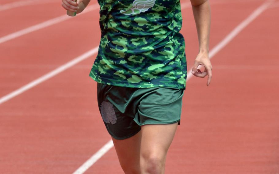 Kubasaki's Rachel Carson runs the third leg of the girls 3,200-meter relay, won by the Dragons in 11 minutes, 17.01 seconds.