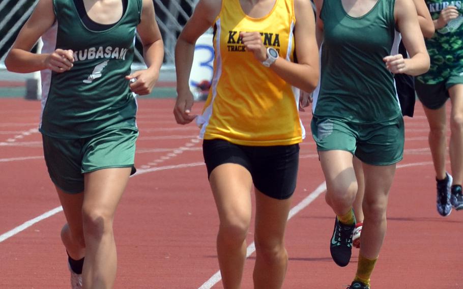 Kubasaki's Zoe Jarvis and Kadena's Wren Renquist run side-by-side in the girls 3,200 with Kubasaki's Rachel Carson in trail. Renquist won this and the 1,600 and gave credit to Jarvis and Carson for pushing her.