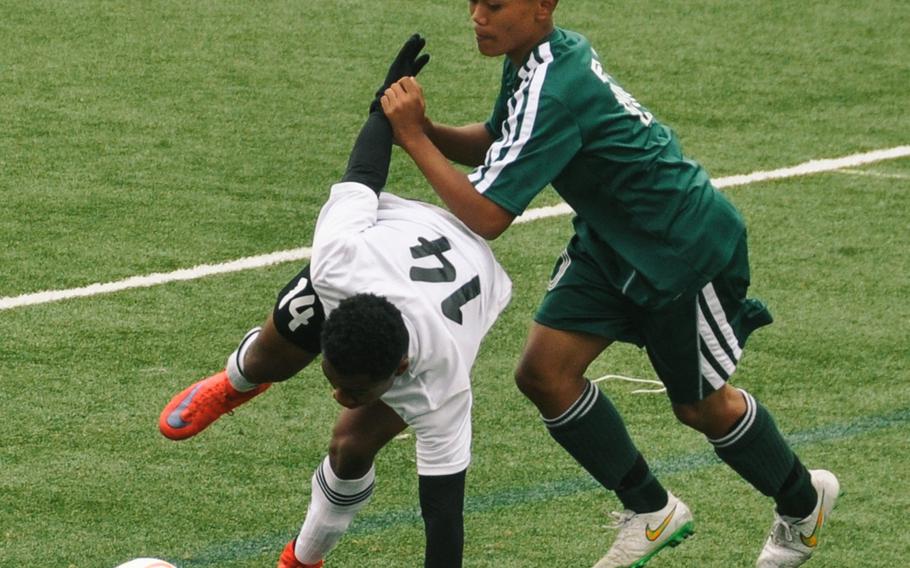 Zama's Malik Wilkes and Edgren's Bradley Juntunen pursue the ball during the team's 0-0 draw in boys D-II soccer action.