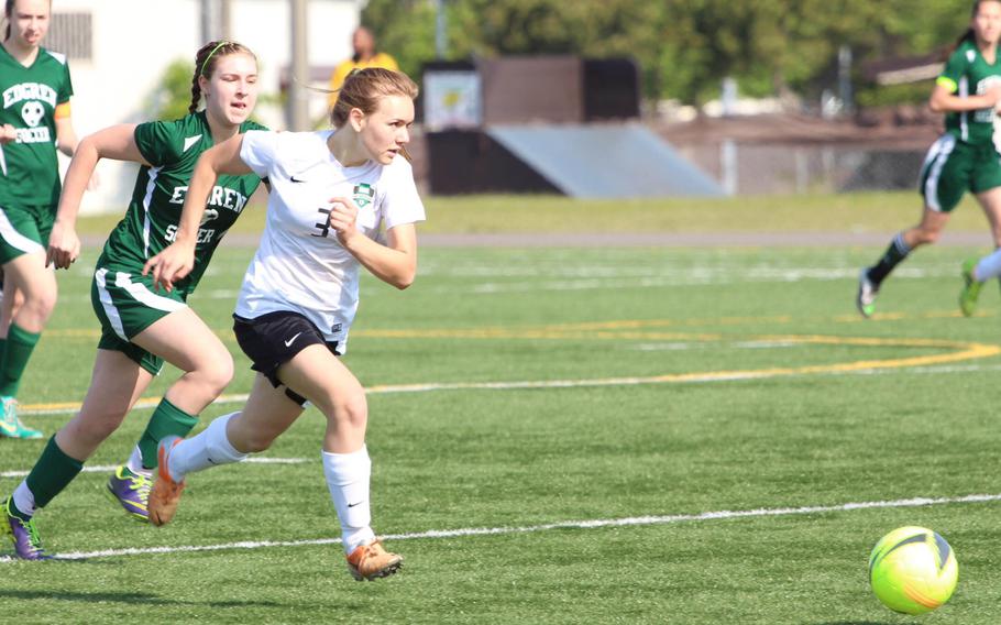 Daegu's Liesel Mendenhall and Edgren's Emma Mattingly pursue the ball during girls D-II soccer action. The Eagles won 4-0.
