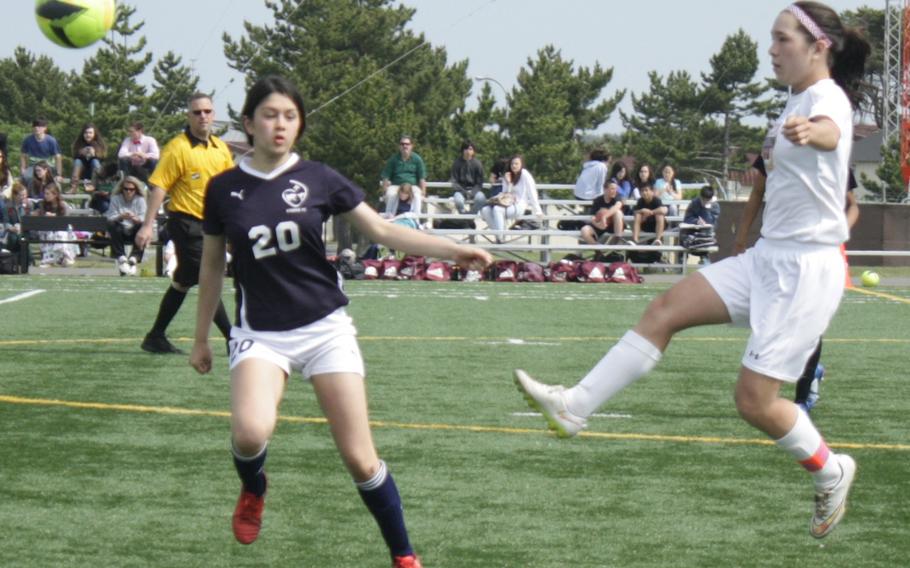 Matthew C. Perry's Bobbi Hill boots the ball past Sacred Heart's Katie Eadon-Clarke during Wednesday's girls D-II soccer semifinal, won by the Samurai 3-0.